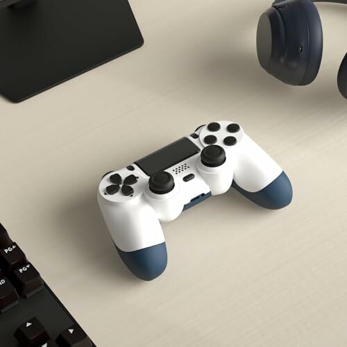 Gaming controller and headphones on a desk.