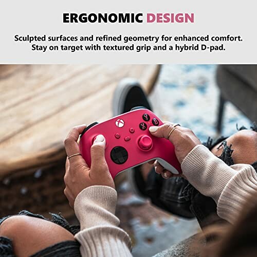 Person holding a red ergonomic gaming controller.