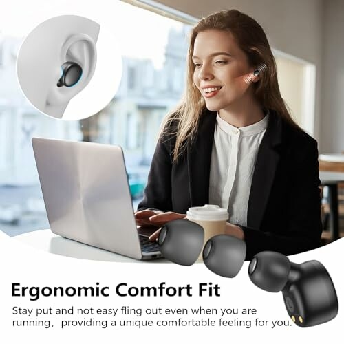 Woman using earbuds while working on a laptop